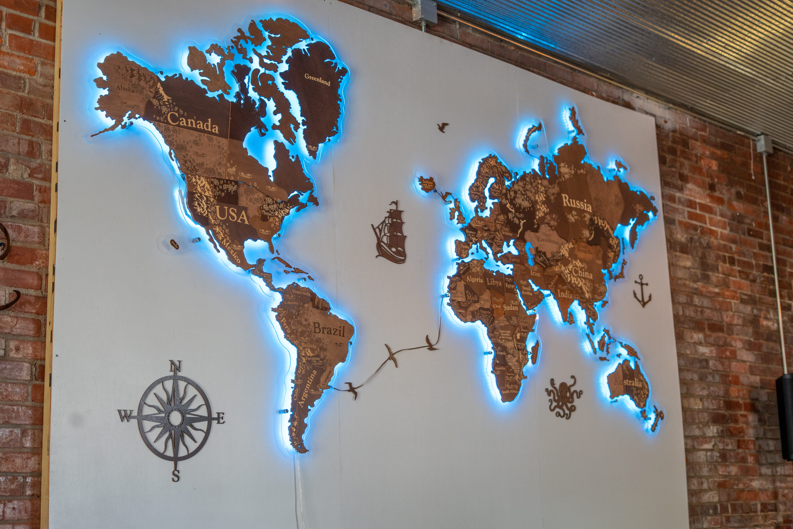 The illuminated world-map wall inside Lock & Keel